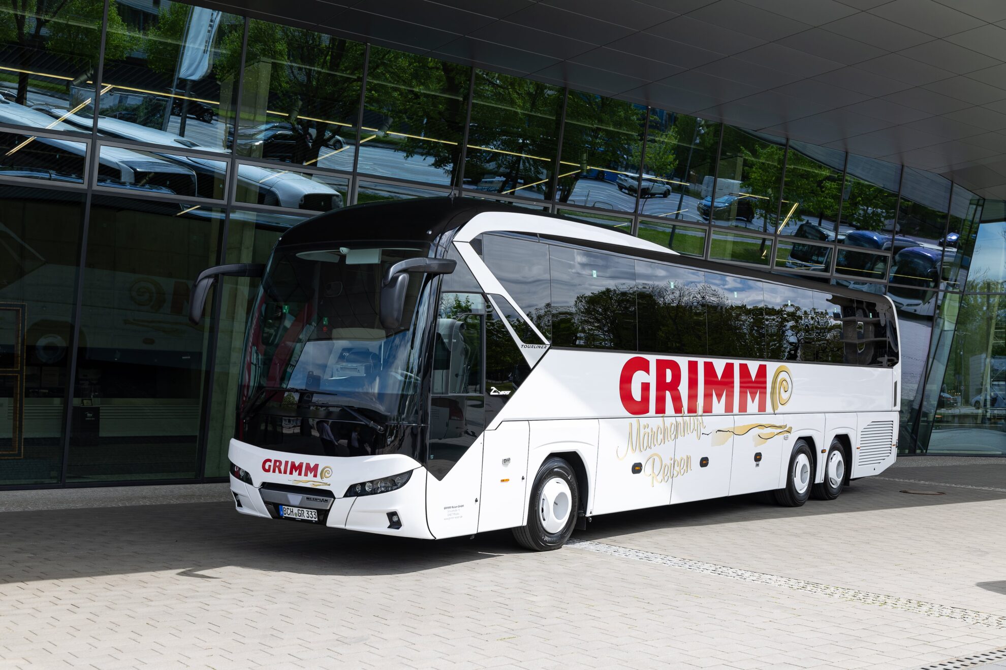 PREMIUM-Fernreisebus Weißer PREMIUM-Fernreisebus mit GRIMM-Aufdruck